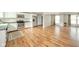 Bright open-concept living room and kitchen with stainless steel appliances and wood flooring at 124 Bess Blvd, Pendleton, IN 46064