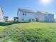Bright backyard featuring healthy lawn and a view of the home's siding and rear windows at 1248 Cassine Pl, Greenwood, IN 46143