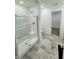 Bathroom features a spacious shower, gray tile, and an adjoining walk-in closet at 1248 Cassine Pl, Greenwood, IN 46143