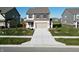 Inviting two-story home featuring a two-car garage, well-manicured lawn, and a long, spacious driveway at 1248 Cassine Pl, Greenwood, IN 46143