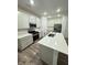 Modern kitchen boasts stainless steel appliances, quartz countertops, and a center island with a sink at 1248 Cassine Pl, Greenwood, IN 46143