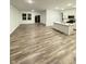 Open-concept living room featuring wood flooring, sliding doors, large windows, and modern kitchen at 1248 Cassine Pl, Greenwood, IN 46143