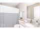 Well-lit bathroom featuring a shower with a striped curtain and granite countertop with a white sink at 12838 Bird Cage, Carmel, IN 46032