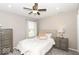 Cozy bedroom features a comfortable bed, dresser, nightstand, and ceiling fan with overhead lighting at 12838 Bird Cage, Carmel, IN 46032