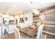 Elegant dining room featuring a rustic accent wall and modern chandelier at 12838 Bird Cage, Carmel, IN 46032