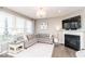 Comfortable living room features a fireplace, plush seating, and a view of the backyard at 12838 Bird Cage, Carmel, IN 46032