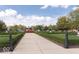 Scenic park featuring manicured hedges, flowers, trees and paved walking path to enjoy nature at 12838 Bird Cage, Carmel, IN 46032