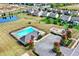A community pool and recreational area are surrounded by well-maintained landscapes, a playground, and ample parking spaces at 14095 Northcoat Pl, Fishers, IN 46038