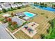 Aerial shot of a beautiful community pool and playground area, with landscaping, ponds, and manicured lawns nearby at 14095 Northcoat Pl, Fishers, IN 46038