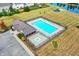 An aerial shot of a community pool offers a relaxing experience with lounge chairs, a hot tub, and well-maintained landscaping at 14095 Northcoat Pl, Fishers, IN 46038