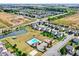 An aerial view of a community with a pool, surrounded by newly constructed homes, picturesque ponds and lush green landscapes at 14095 Northcoat Pl, Fishers, IN 46038