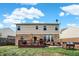 Spacious backyard with a deck, patio furniture, well-maintained lawn, and mature trees at 14095 Northcoat Pl, Fishers, IN 46038