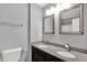 Bathroom featuring a granite countertop, double sinks, and dark cabinetry at 14095 Northcoat Pl, Fishers, IN 46038