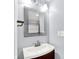 Stylish bathroom vanity with a modern sink, framed mirror, and decorative lighting fixtures at 14095 Northcoat Pl, Fishers, IN 46038
