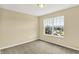 Cozy bedroom has a bright window with neighborhood views and a neutral color palette creating a serene space at 14095 Northcoat Pl, Fishers, IN 46038