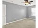 Neutral bedroom has a ceiling fan and a bright window, offering a calm and airy ambiance at 14095 Northcoat Pl, Fishers, IN 46038