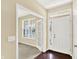 Bright entryway with white double doors, leading to a carpeted room and dark hardwood floors at entry at 14095 Northcoat Pl, Fishers, IN 46038