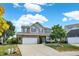 Beautiful two-story house with a front lawn, driveway, and a blue sky with scattered clouds above at 14095 Northcoat Pl, Fishers, IN 46038