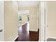 Hallway with hardwood flooring, and doorways leading to multiple rooms including a living room and bedroom at 14095 Northcoat Pl, Fishers, IN 46038