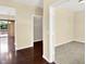 Interior view of a hallway with dark hardwood floors, and doorways leading to multiple rooms and an outside deck at 14095 Northcoat Pl, Fishers, IN 46038