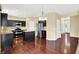 Modern kitchen with dark cabinetry, granite countertops, and stainless steel appliances at 14095 Northcoat Pl, Fishers, IN 46038
