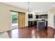 Well-appointed kitchen with black cabinets, hardwood floors, and access to a deck at 14095 Northcoat Pl, Fishers, IN 46038