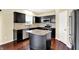 Stylish kitchen with dark cabinets, an island, stainless appliances, and granite countertops at 14095 Northcoat Pl, Fishers, IN 46038