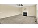 Spacious living room with a fireplace, neutral walls, and plush carpeting at 14095 Northcoat Pl, Fishers, IN 46038