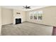 Bright living room featuring a fireplace, large windows, and neutral carpeting at 14095 Northcoat Pl, Fishers, IN 46038