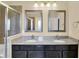 Main bathroom features double vanity, granite countertop, shower, and mirrors at 14095 Northcoat Pl, Fishers, IN 46038