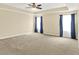 Spacious main bedroom features neutral colors, a tray ceiling, and plush carpet at 14095 Northcoat Pl, Fishers, IN 46038