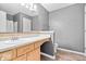 Neutral-toned bathroom featuring a light-wood vanity, and a framed mirror with ample lighting at 143 W Clear Lake Ct, Westfield, IN 46074
