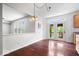 Bright dining area featuring hardwood floors, french doors to the patio, and modern lighting at 143 W Clear Lake Ct, Westfield, IN 46074