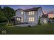 Exterior view of the home showcasing a well-maintained backyard, patio, and gazebo setup at 143 W Clear Lake Ct, Westfield, IN 46074