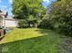 Lush backyard featuring mature trees and a spacious lawn at 146 E Broadway St, Shelbyville, IN 46176