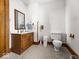 Bright bathroom with a wooden vanity, classic fixtures, and a neutral color scheme at 146 E Broadway St, Shelbyville, IN 46176