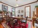 A dining room with vintage charm featuring classic wood trim and a patterned red rug at 146 E Broadway St, Shelbyville, IN 46176