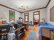 A well-lit office featuring hardwood floors, wood trim, with views into an adjoining living space at 146 E Broadway St, Shelbyville, IN 46176