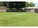 Extensive backyard featuring lush lawn, mature trees, and a charming shed, perfect for outdoor activities at 1504 Gwinn Ln, Lapel, IN 46051