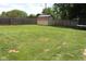 Large backyard with lush green grass, a storage shed, and ample space for recreation and relaxation at 1504 Gwinn Ln, Lapel, IN 46051