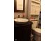 Stylish bathroom with dark vanity and modern sink, complemented by matching toilet and storage cabinet at 1504 Gwinn Ln, Lapel, IN 46051