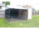 Spacious and secure outdoor dog kennel with covered area, providing a safe and comfortable space for pets at 1504 Gwinn Ln, Lapel, IN 46051