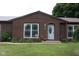 Charming brick home entrance featuring a well-maintained lawn and classic white front door at 1504 Gwinn Ln, Lapel, IN 46051