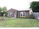 Charming brick home with metal roof, manicured lawn, mature landscaping, and lovely curb appeal at 1504 Gwinn Ln, Lapel, IN 46051