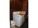 Cozy laundry room with matching washer and dryer, accented by dark wood cabinetry and built in folding area at 1504 Gwinn Ln, Lapel, IN 46051