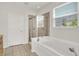 Bright bathroom featuring a tiled shower, a soaking tub, and a window that provides natural light at 16130 Matlock Cir, Westfield, IN 46074
