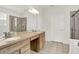 Stylish bathroom showcasing double sinks, a large mirror, a glass-enclosed shower, and tiled floors at 16130 Matlock Cir, Westfield, IN 46074