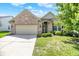 Charming single-story brick home with a well-manicured lawn and an attached two-car garage at 16130 Matlock Cir, Westfield, IN 46074