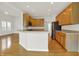 Charming kitchen boasts a center island with bar seating, stainless appliances, and wood flooring at 16130 Matlock Cir, Westfield, IN 46074
