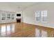 Bright and spacious living room with hardwood floors, a fireplace, and large windows at 16130 Matlock Cir, Westfield, IN 46074